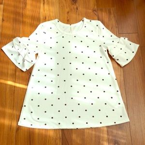 Ruffle sleeve polka dot shirt.